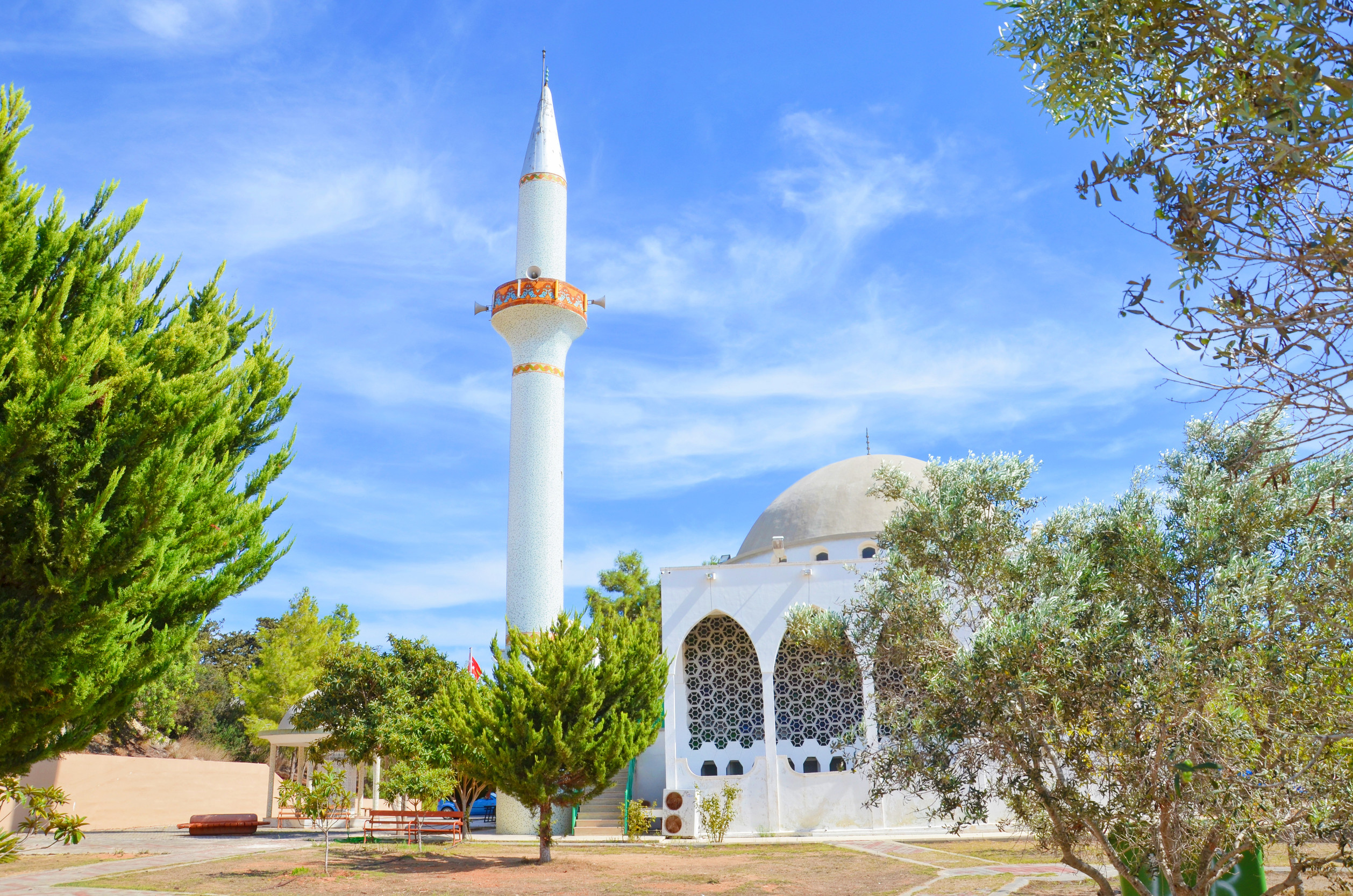 beautiful islamic mosque in dipkarpaz northern cyprus surrounded by small park with green trees