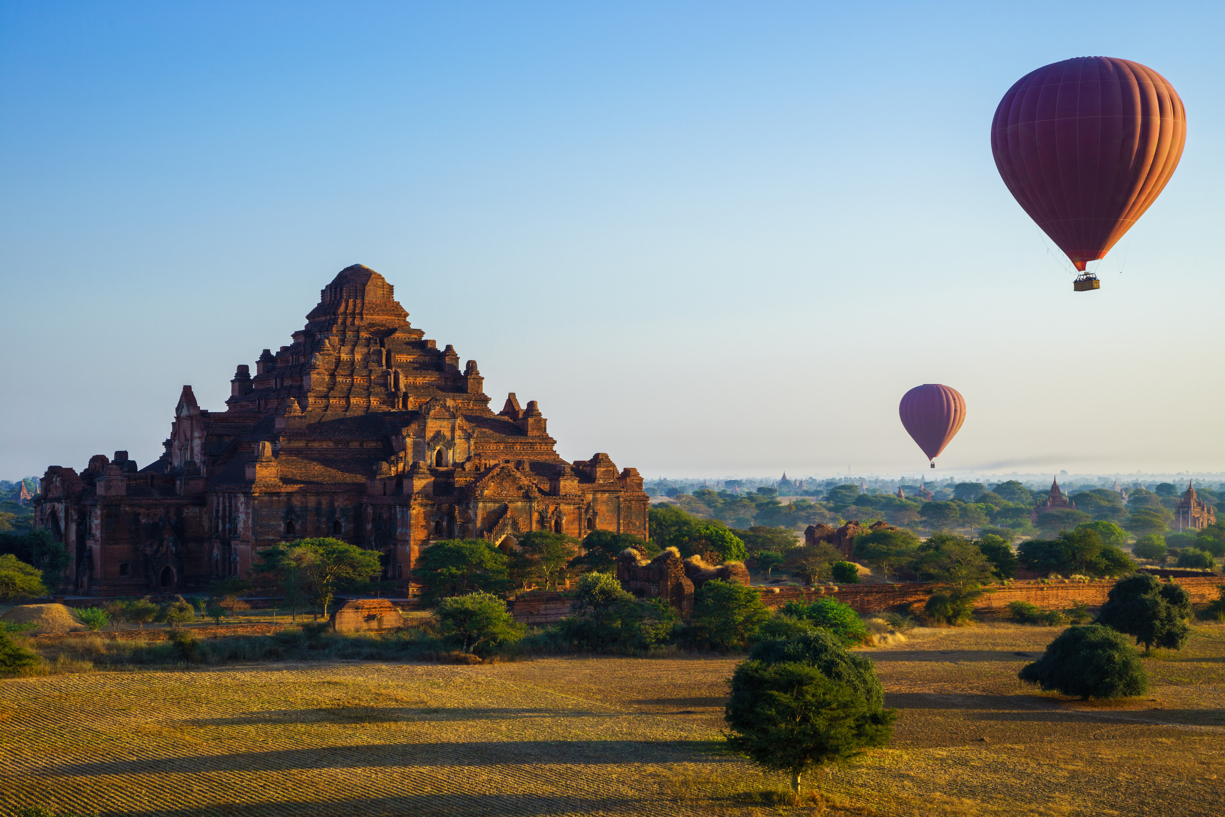 beautiful outdoor view of a group of tourists in tourist boats visiting the golden budha located