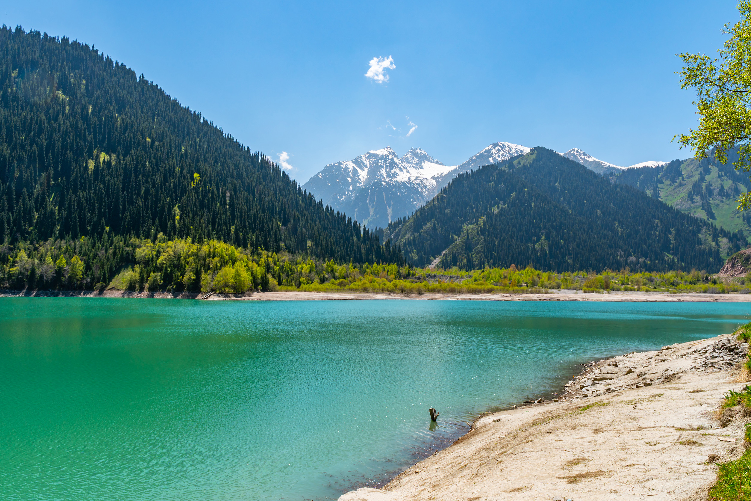 esik lake issyk picturesque breathtaking view with snow capped mountains on a sunny blue sky