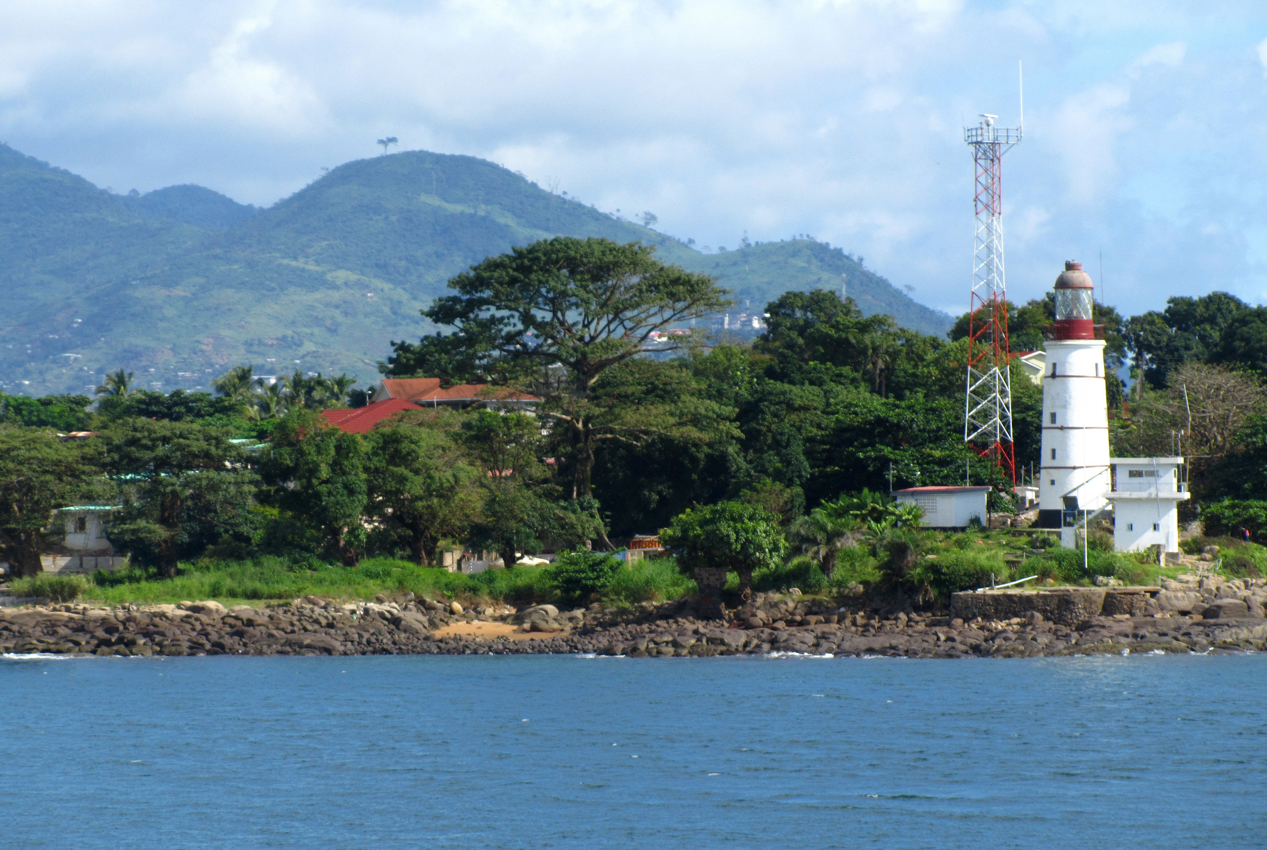 calm water palm trees and white sand beach at tokeh beach south of freetown sierra leone