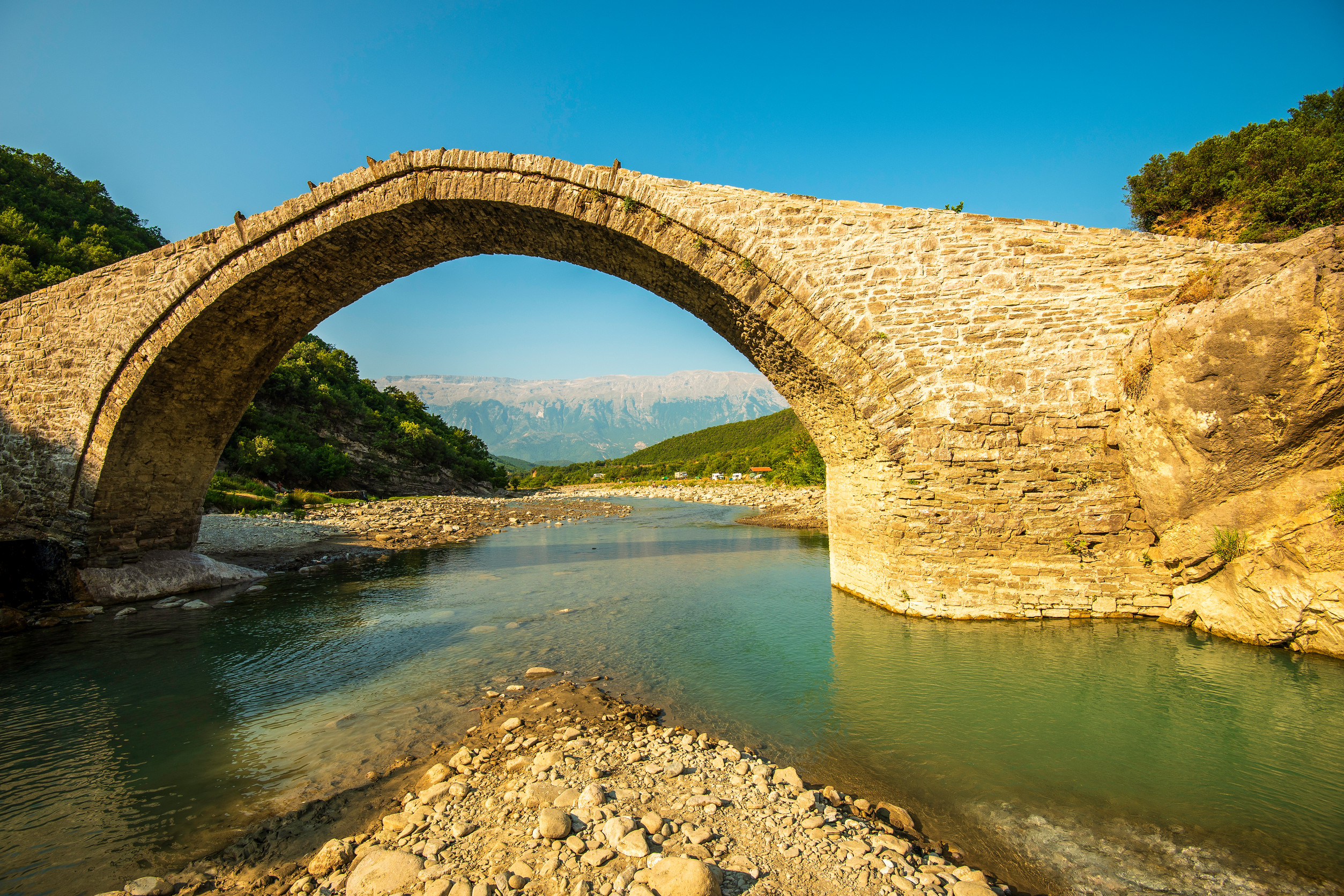 majestic stone arch of ura e katiut spanning langarica canyon timeless