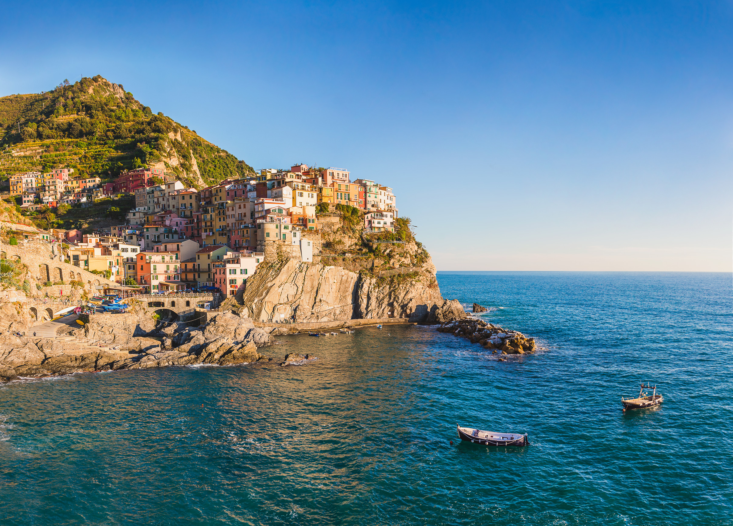 manarola cinque terre italy before sunset with boats floating