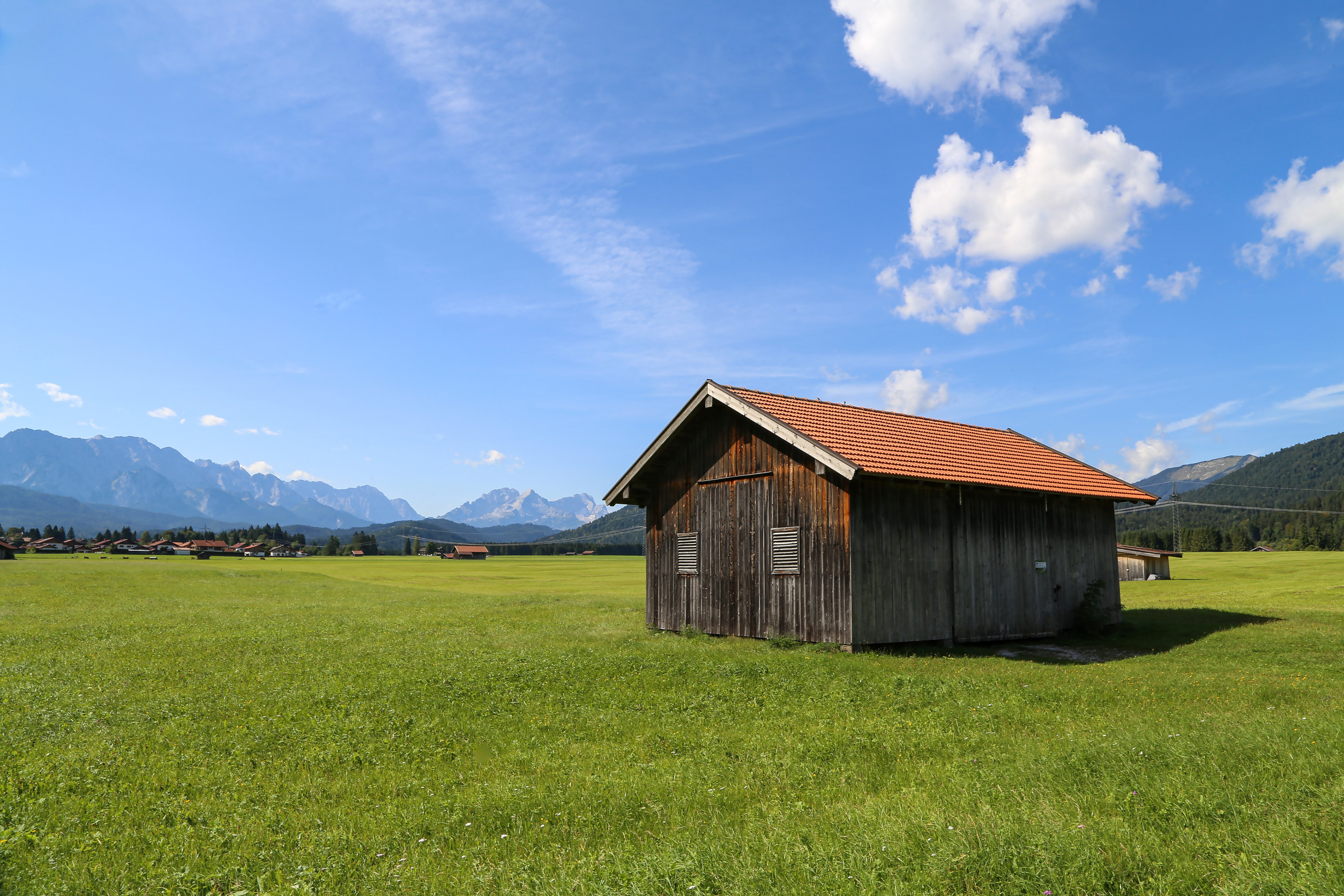 mountain huts on green meadows in the alps