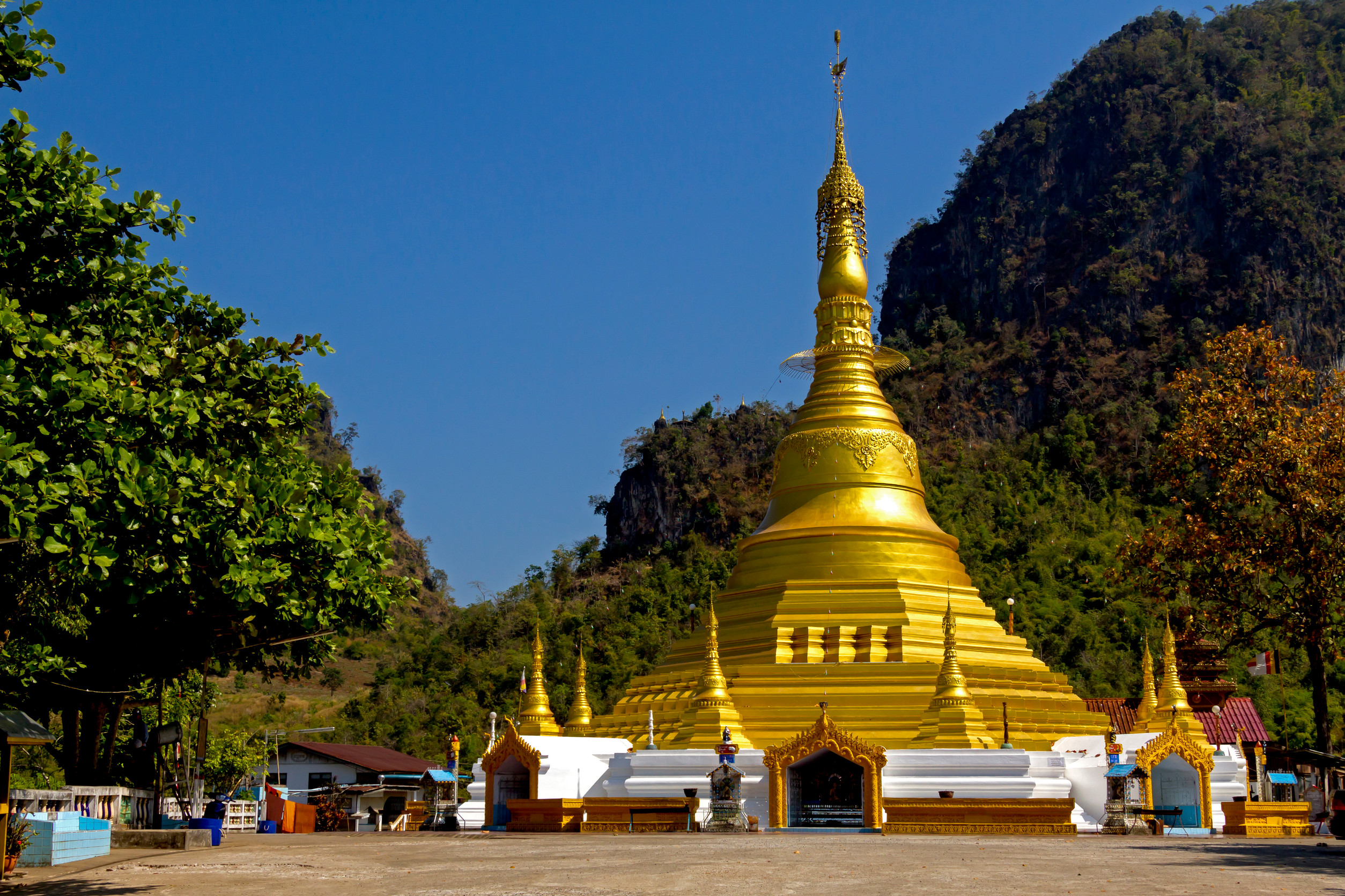 beautiful outdoor view of a group of tourists in tourist boats visiting the golden budha located