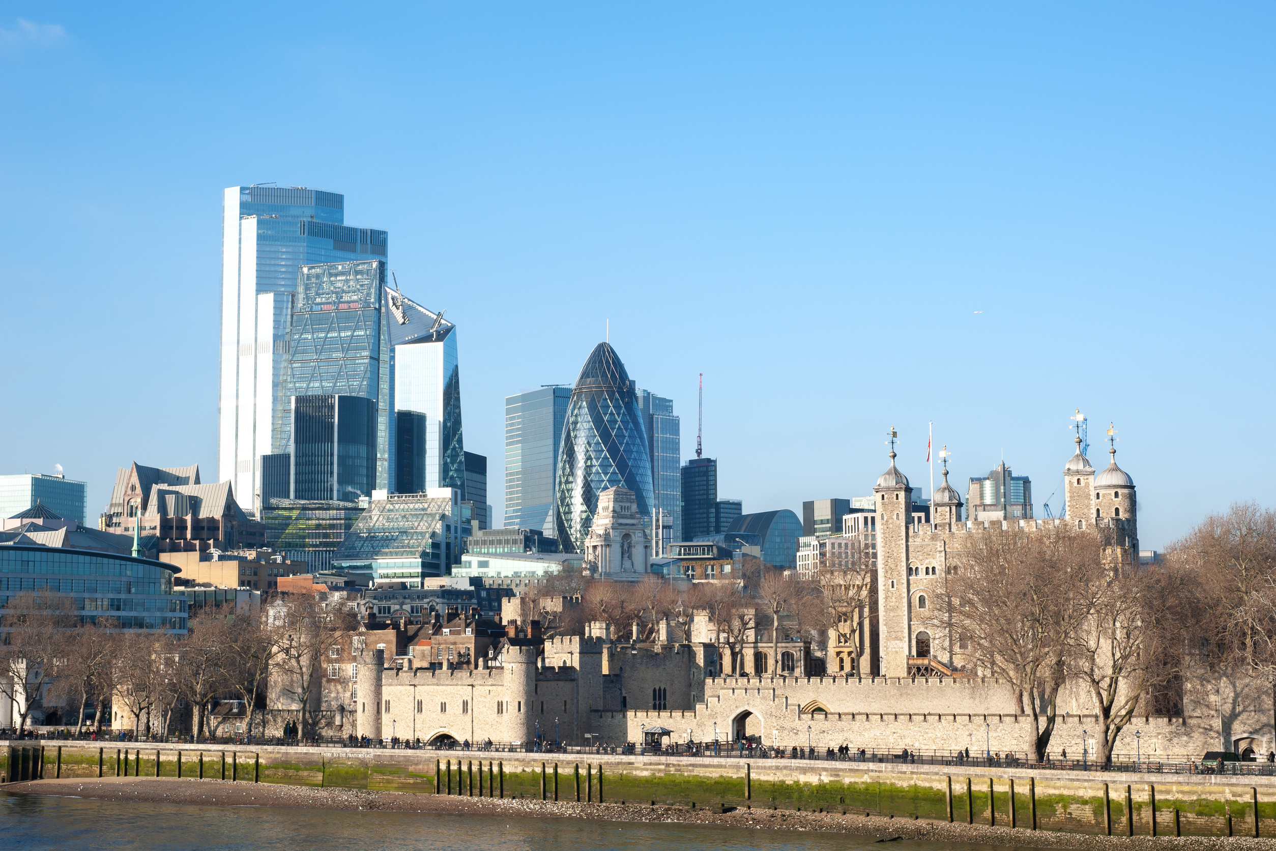 tower of london overlooked by the gherkin building and the skyscraperstower of london overlooked by the gherkin building and the skyscrapers